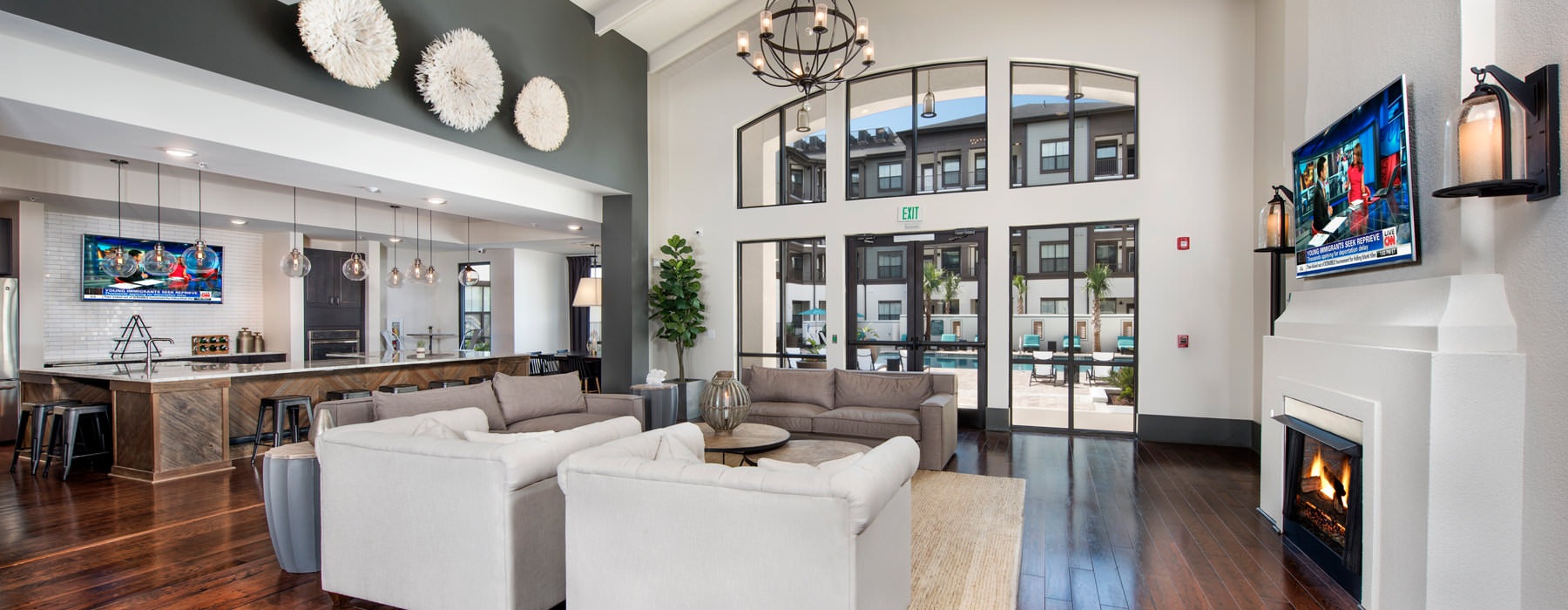 Open clubhouse with high ceilings, wood floors, and community kitchen